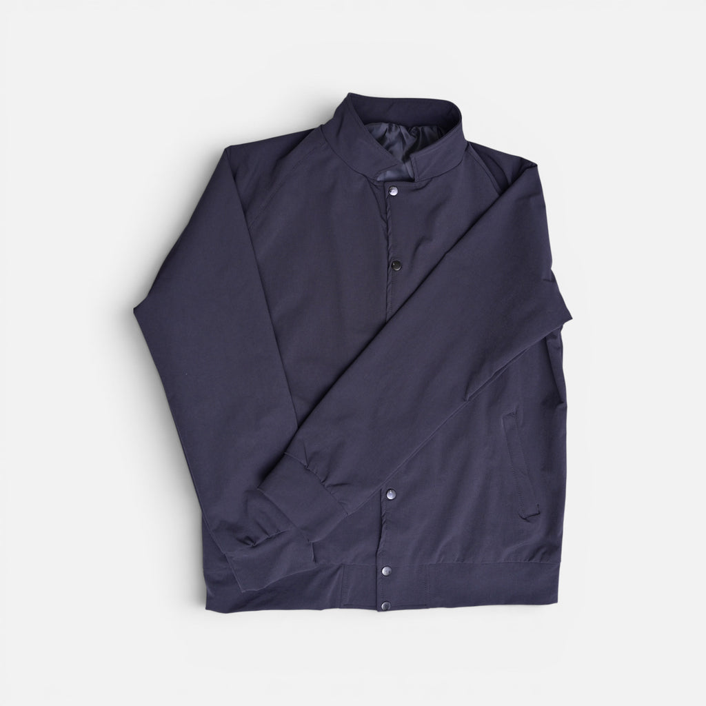 Navy blue button varsity terry jacket folded flat lay